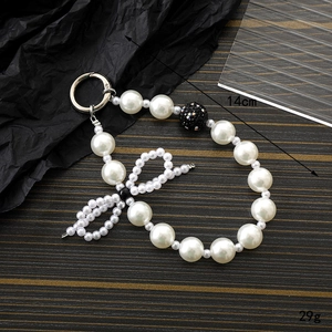 Elegant pearl bow keychain charm with silver spring clasp for bags and phone cases