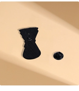 Detail view of the black metal enamel pin back with secure butterfly clutch fastener