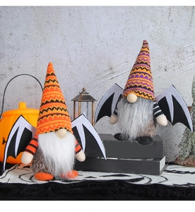 Close-up of Halloween gnomes featuring knitted striped hats and black bat wings