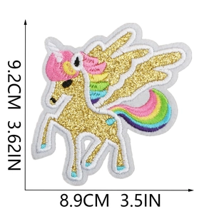 Detail view of unicorn embroidery patch with rainbow mane and gold glitter horn
