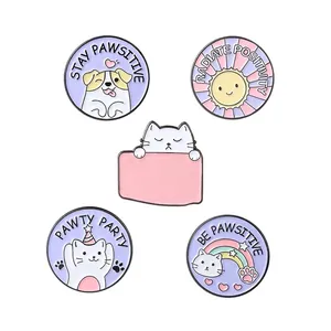 Set of 5 cartoon cat and dog enamel badges with positive paw-themed slogans on white background