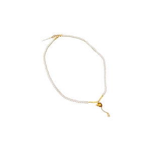 Elegant pearl necklace with golden snake pendant and zircon stone on white background