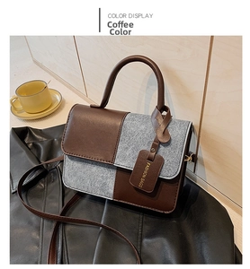 Detail of coffee brown leather and grey wool patchwork texture on a small square bag