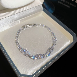 Detailed close-up of a sparkling zircon double-layer bracelet with premium 18k gold plating.