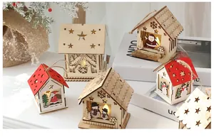 Close-up of glowing wooden Christmas house ornament with warm LED light and reindeer cutout