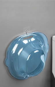 Blue bidet basin featuring a hanging hole and wave edge design on a bathroom wall