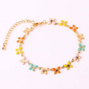 Detail of gold chain bracelet with colorful enamel butterfly charms and lobster clasp