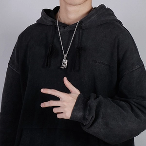 Punk style men boxing glove pendant necklace worn with a black distressed hoodie