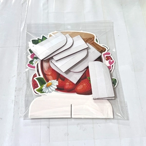 Unopened strawberry theme paper party centerpiece set in transparent packaging