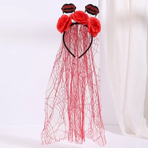 Detail of Halloween headband with red roses, black mesh veil, and sequin bat accents