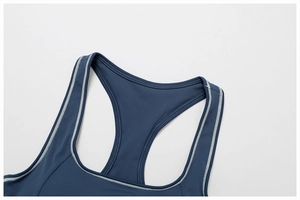 Detail view of contrast white stitching on a dark blue racerback yoga bra neckline