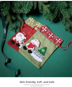 Detail of red and green Christmas drawstring gift bags with 3D Santa and Snowman embroidery
