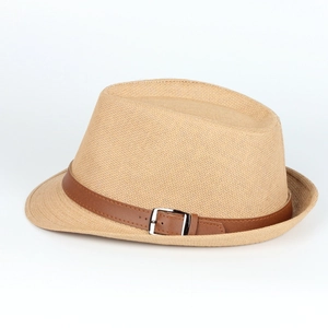 Close-up of woven straw texture with brown leather band and silver metal buckle
