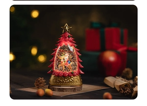 Detail of Christmas tree snow globe with Santa and reindeer on a warm bokeh background