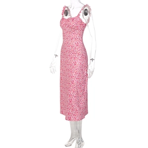 Detail view of pink floral midi dress with red flower print and waist-cinching silhouette