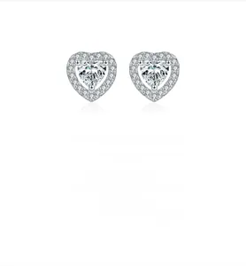Macro detail of S925 sterling silver heart stud earrings with sparkling moissanite stones