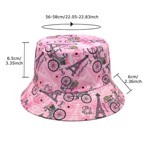 Reversible bucket hat with pink retro patterns featuring Eiffel Tower and bicycles