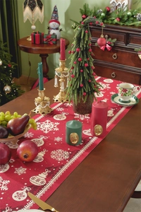 Close-up of red Christmas table runner featuring white snowflakes and festive ornaments