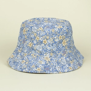 Detailed top view of the blue floral bucket hat with delicate yellow and white flower patterns