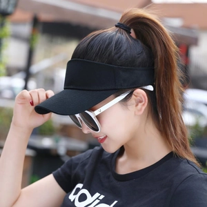 Outdoor view of a black sun visor baseball hat for men and women with adjustable open top