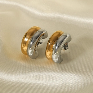 Polished gold and silver two-tone double layer C-shaped earrings on silk fabric