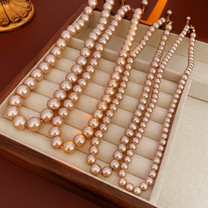 Elegant champagne gold pearl necklaces in a luxury jewelry display box for women