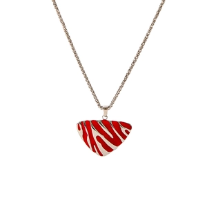 Detailed view of silver necklace featuring a triangular pendant with red striped enamel finish