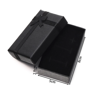 Detail view of a black textured jewelry gift box with a ribbon, size 8cm x 5cm x 2.8cm