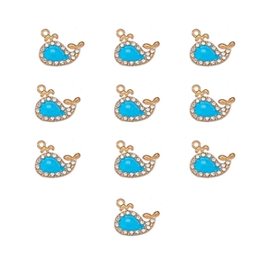 Detailed grid view of whale shaped alloy pendants with blue enamel and rhinestones