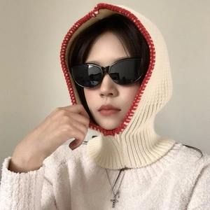 Close-up of white knit balaclava scarf with red contrast stitching details