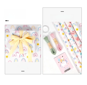 Rainbow and polka dot gift wrapping paper rolls set with birthday card and cotton twine