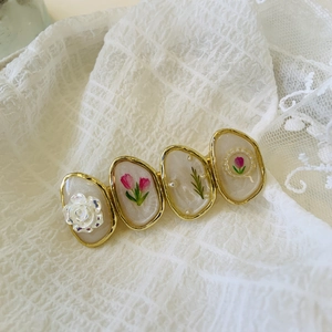French vintage floral hair clip with gold trim roses and cream resin on white lace
