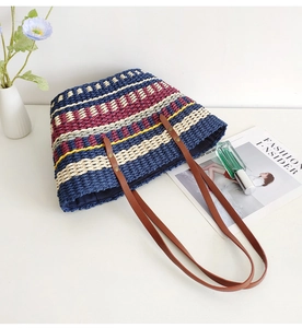 Close-up of vibrant rainbow striped woven texture and premium brown leather handle detail