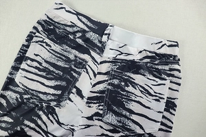Detailed view of the zebra print trousers' back pockets and precise stitching texture