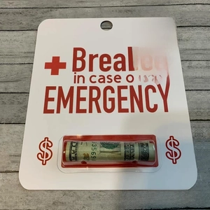 Detail of creative emergency money holder card with 20 dollar bill and red text