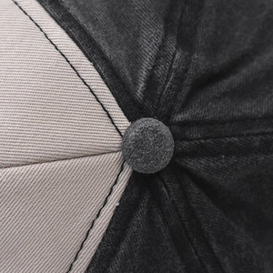 Detailed macro view of the two-tone cotton baseball cap crown with high-quality stitching