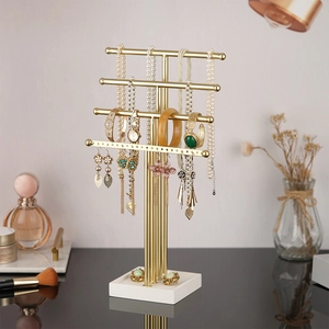 Golden 4-tier T-bar jewelry stand with white base for organizing necklaces and earrings