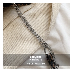 Detail of silver metal chain strap and hardware on leopard print shoulder bag