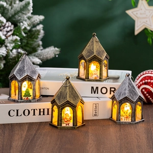 Close-up of four vintage LED Christmas lanterns with warm lighting on decorative books
