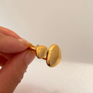 Detailed macro shot of 18k gold plated stainless steel ring with dual polished pebble shapes