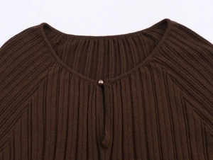 Close-up of brown ribbed knit sweater neckline with a matching small bead button detail