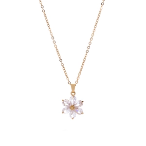 Detail of a golden flower pendant with six transparent zircon petals and a gold core