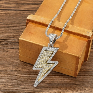 Close-up of iced out lightning bolt pendant with crystals on silver twisted rope chain
