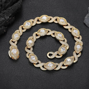 Iced out gold Cuban link chain with infinity eye links and round zircons on black rock