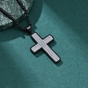 Minimalist black and silver stainless steel cross pendant necklace on green stone base