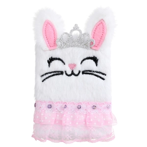 Close-up of white plush bunny notebook with silver sequin crown and lace trim details