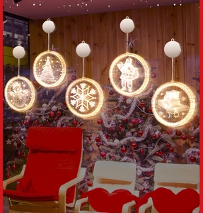 Detailed view of warm LED Christmas window suction lights with acrylic festive patterns