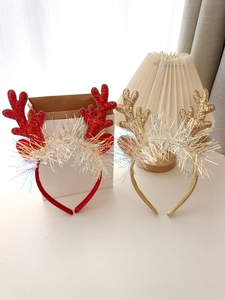 Detail of glitter reindeer antler headbands with colorful laser tassels for Christmas party
