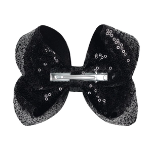 Detail view of large black sequin hair bow with silver metal alligator clip on reverse