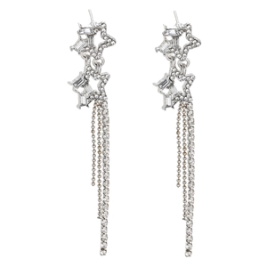 Macro shot of silver dangling star earrings with sparkling zircon tassels and fringe
